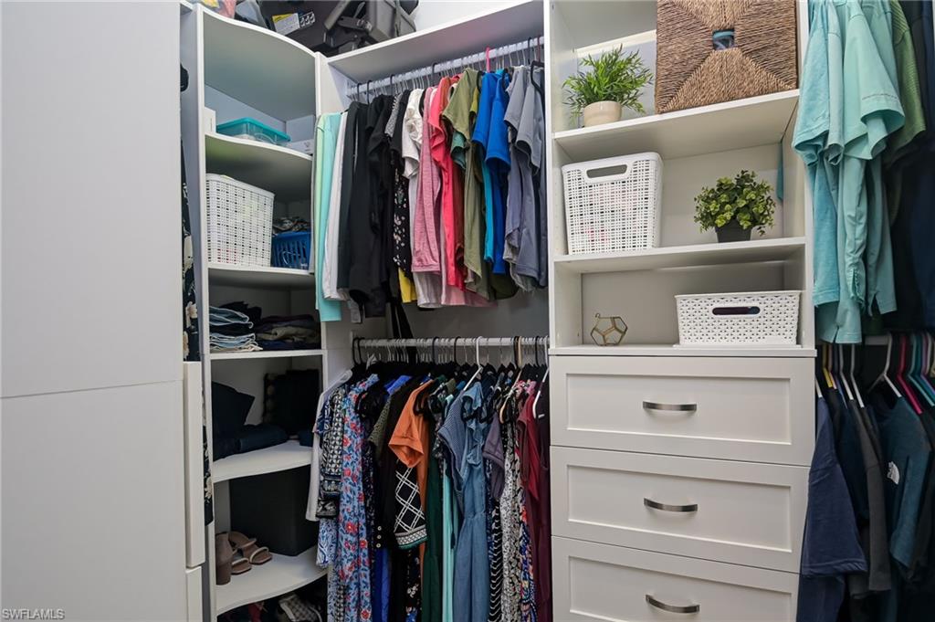 2137 Clementine Street Naples, FL 34120 - Photo 18 of 32 a view of walk in closet with clothes and shoes