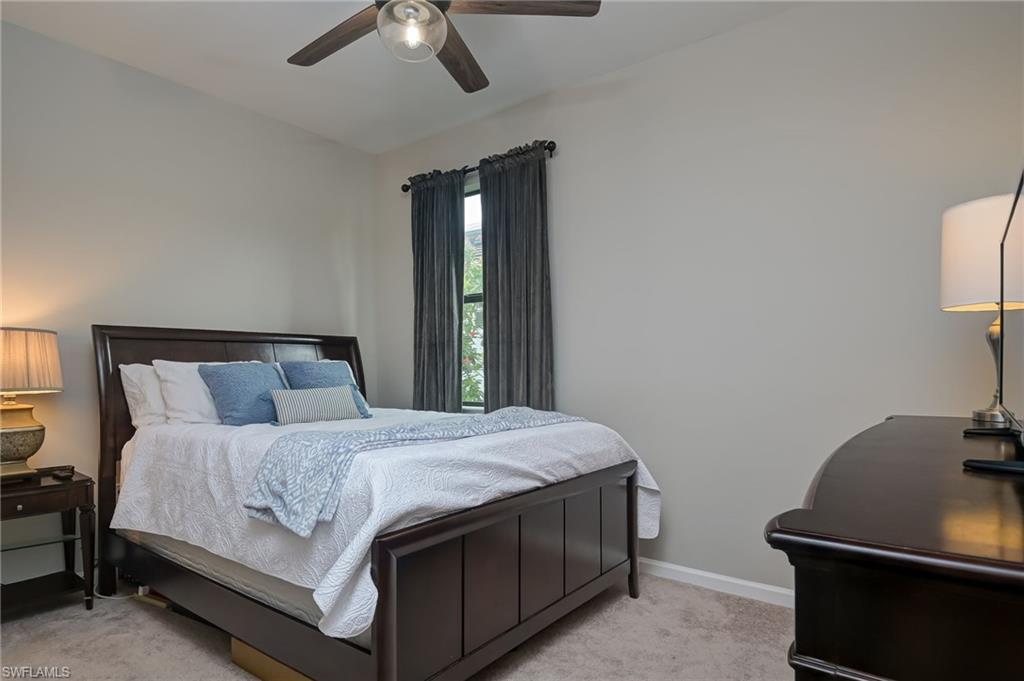 2137 Clementine Street Naples, FL 34120 - Photo 22 of 32 a bedroom with a bed and a desk