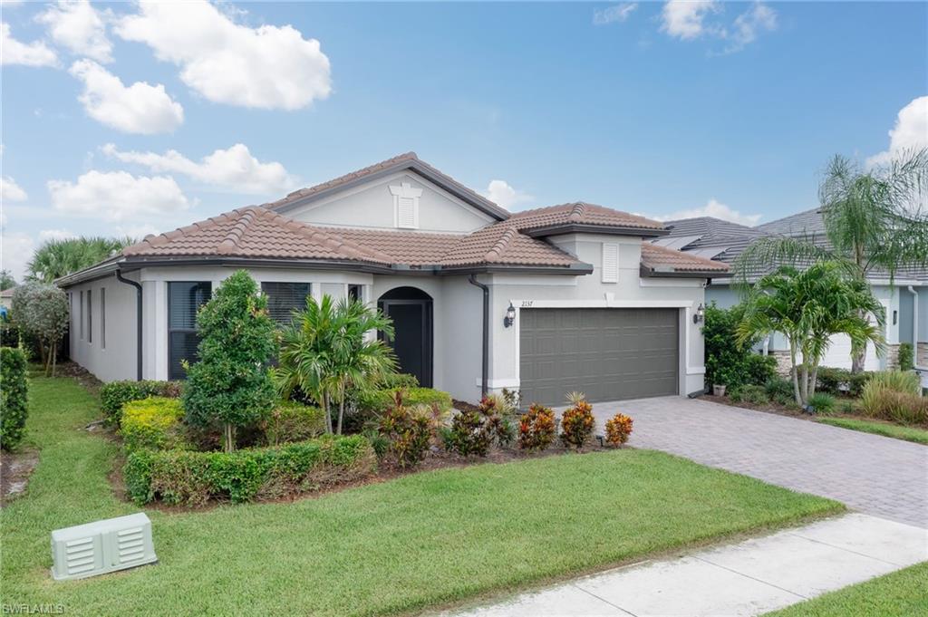 2137 Clementine Street Naples, FL 34120 - Photo 29 of 32 a front view of house with yard and green space