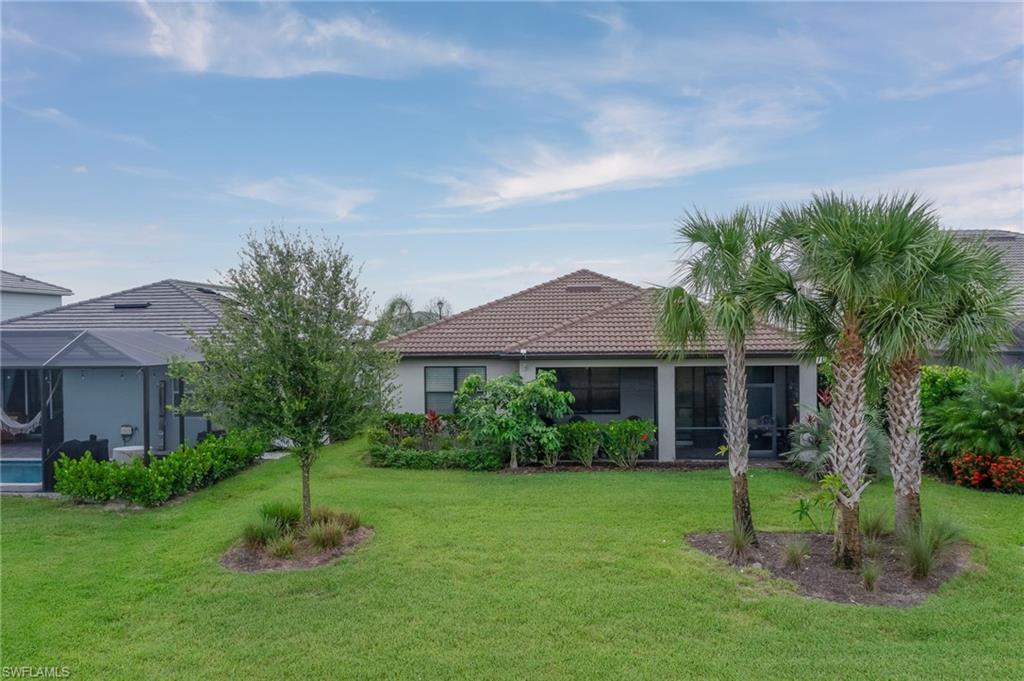 2137 Clementine Street Naples, FL 34120 - Photo 31 of 32 a view of a house with a yard and potted plants