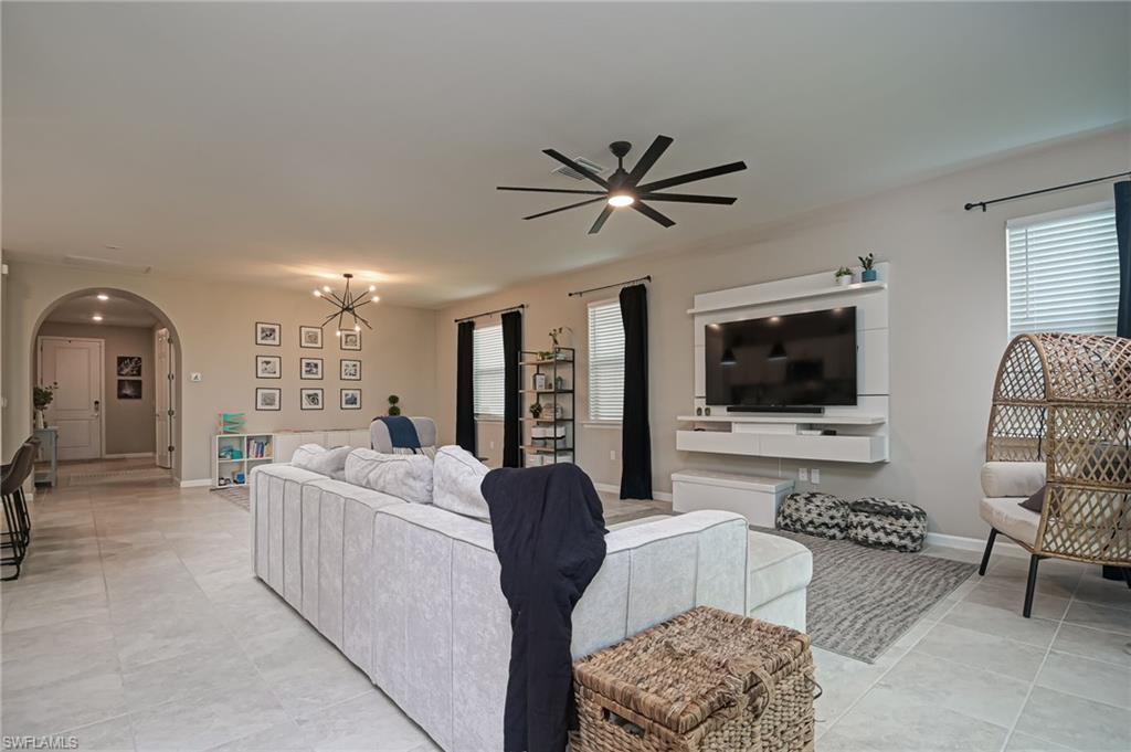 2137 Clementine Street Naples, FL 34120 - Photo 5 of 32 a living room with furniture a flat screen tv and a couch