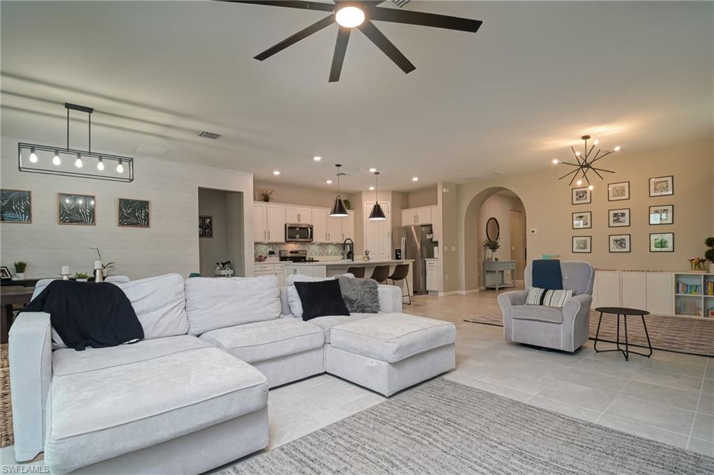 2137 Clementine Street Naples, FL 34120 - Photo 6 of 32 a living room with furniture and a chandelier