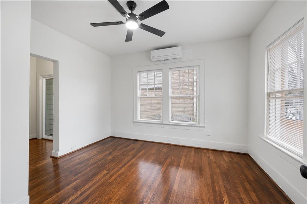 405 4th Street Northeast, Unit 24 Atlanta, GA 30308 - Photo 11 of 19 a view of an empty room with wooden floor and a window