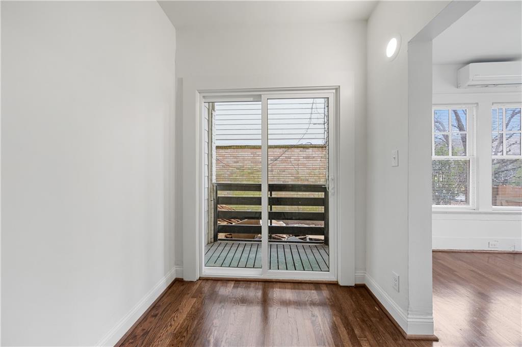 405 4th Street Northeast, Unit 24 Atlanta, GA 30308 - Photo 14 of 19 an empty room with wooden floor and windows