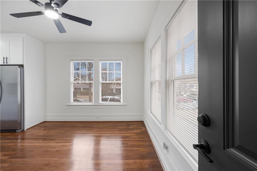 405 4th Street Northeast, Unit 24 Atlanta, GA 30308 - Photo 3 of 19 a view of an empty room with wooden floor and a window