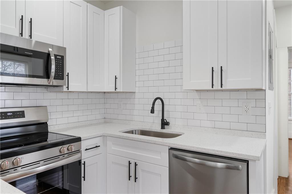405 4th Street Northeast, Unit 24 Atlanta, GA 30308 - Photo 6 of 19 a kitchen with sink stainless steel appliances and cabinets