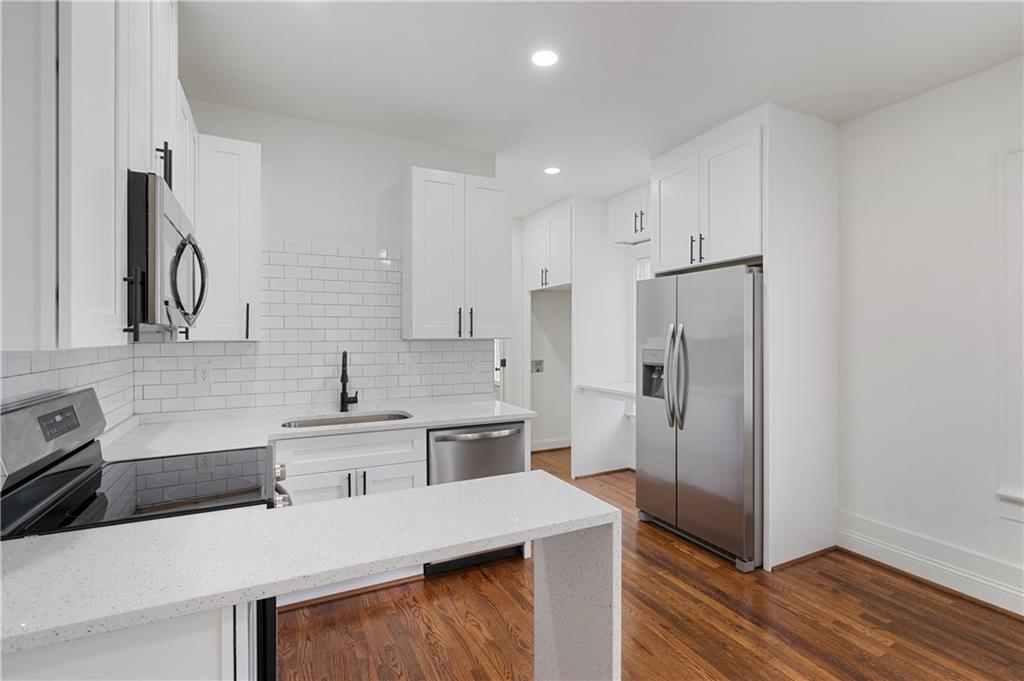 405 4th Street Northeast, Unit 24 Atlanta, GA 30308 - Photo 8 of 19 a kitchen with stainless steel appliances a sink cabinets and wooden floor