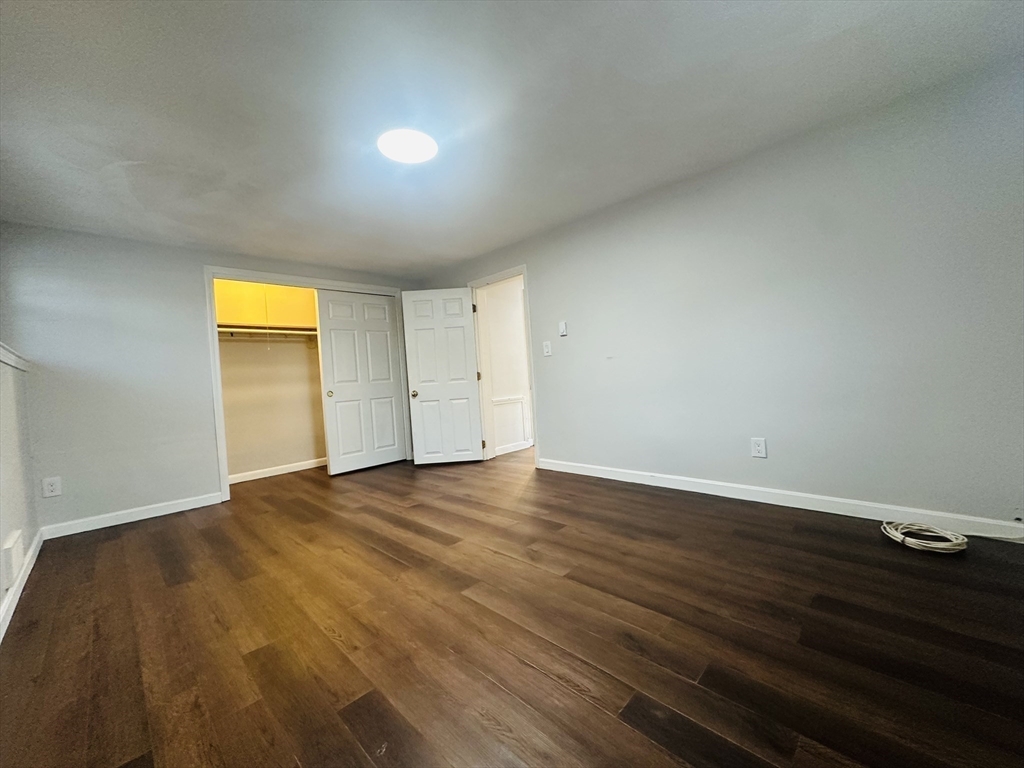 222 School Street, Unit 4 Walpole, MA 02081 - Photo 12 of 16 a view of empty room with wooden floor and closet