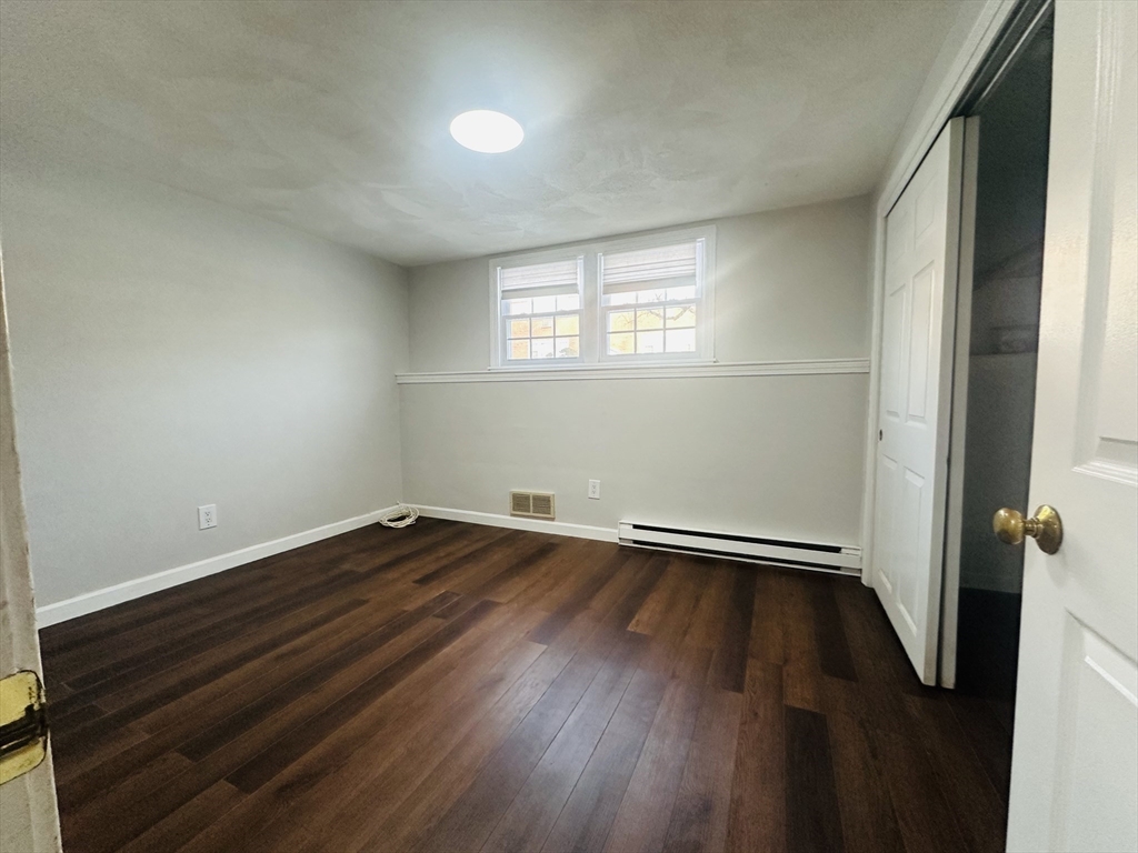222 School Street, Unit 4 Walpole, MA 02081 - Photo 15 of 16 an empty room with wooden floor and windows