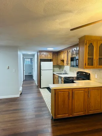a kitchen with stainless steel appliances granite countertop a sink and wooden floor