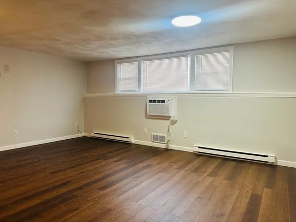 an empty room with wooden floor