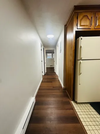 a view of a hallway with wooden floor