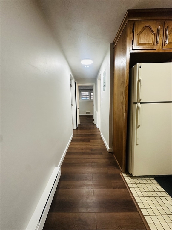 222 School Street, Unit 4 Walpole, MA 02081 - Photo 9 of 16 a view of a hallway with wooden floor