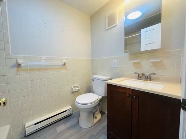 a bathroom with a sink toilet and vanity