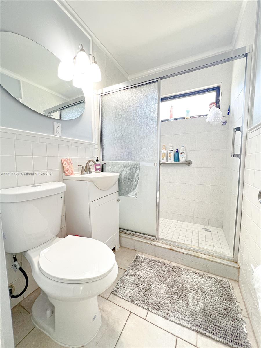 515 Valley Forge Road West Palm Beach, FL 33405 - Photo 9 of 9 a white toilet sitting next to a bathroom sink