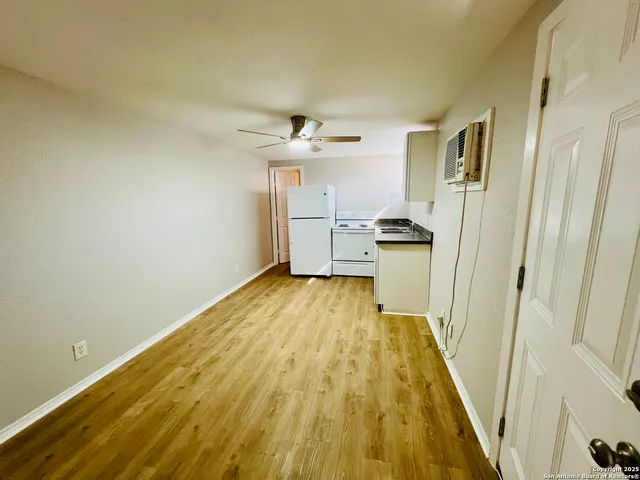 a view of a kitchen from a hallway