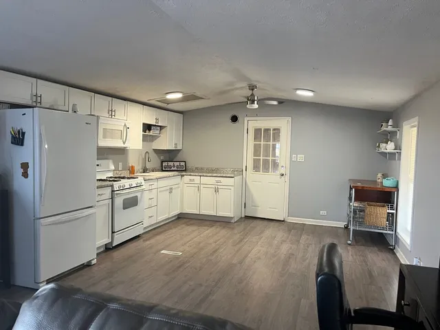 a kitchen with stainless steel appliances a refrigerator sink and cabinets