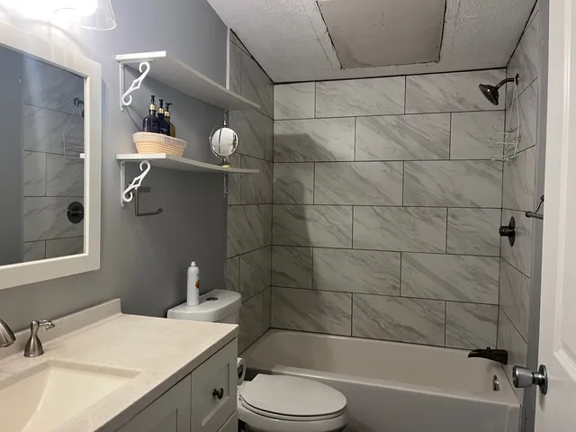 a bathroom with a sink toilet and shower