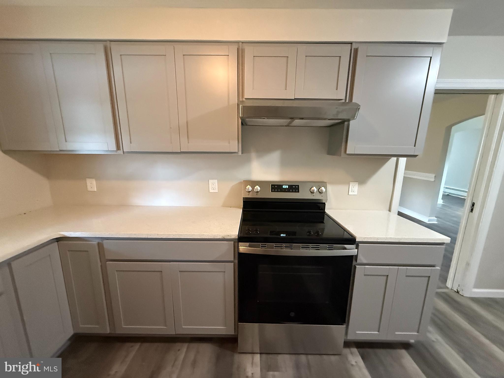17 Wayne Road Bridgeton, NJ 08302 - Photo 27 of 49 a kitchen with white cabinets and black appliances