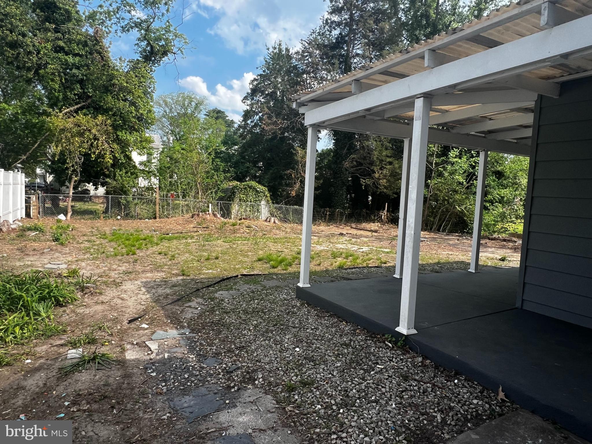 17 Wayne Road Bridgeton, NJ 08302 - Photo 4 of 49 a view of a yard with porch and wooden fence