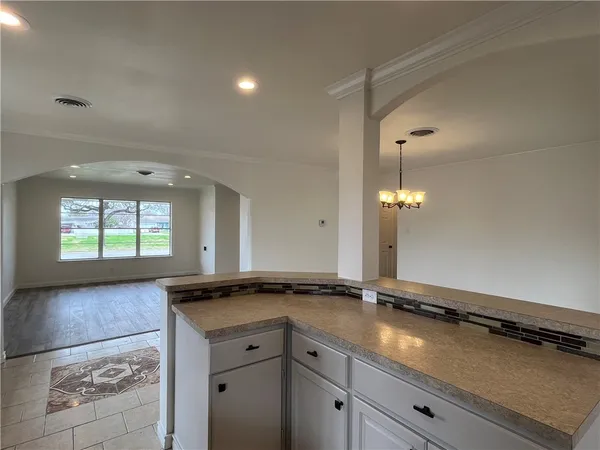 a view of a sink and cabinets in a room