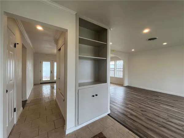 wooden floor in a hall with an empty room