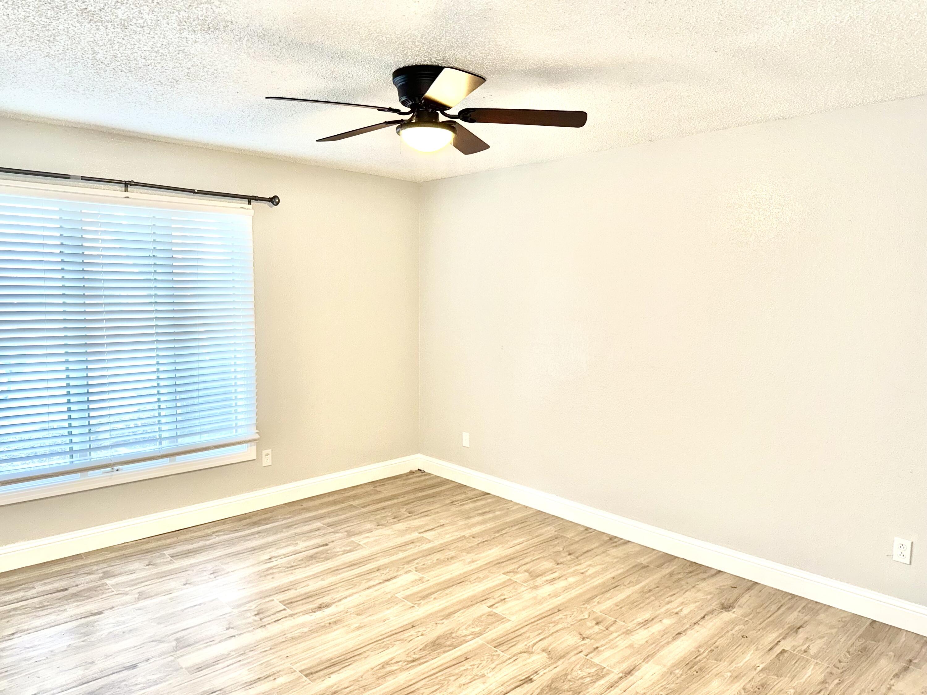 5415 73rd Street Lubbock, TX 79424 - Photo 13 of 13 a view of a room with a ceiling fan and a window