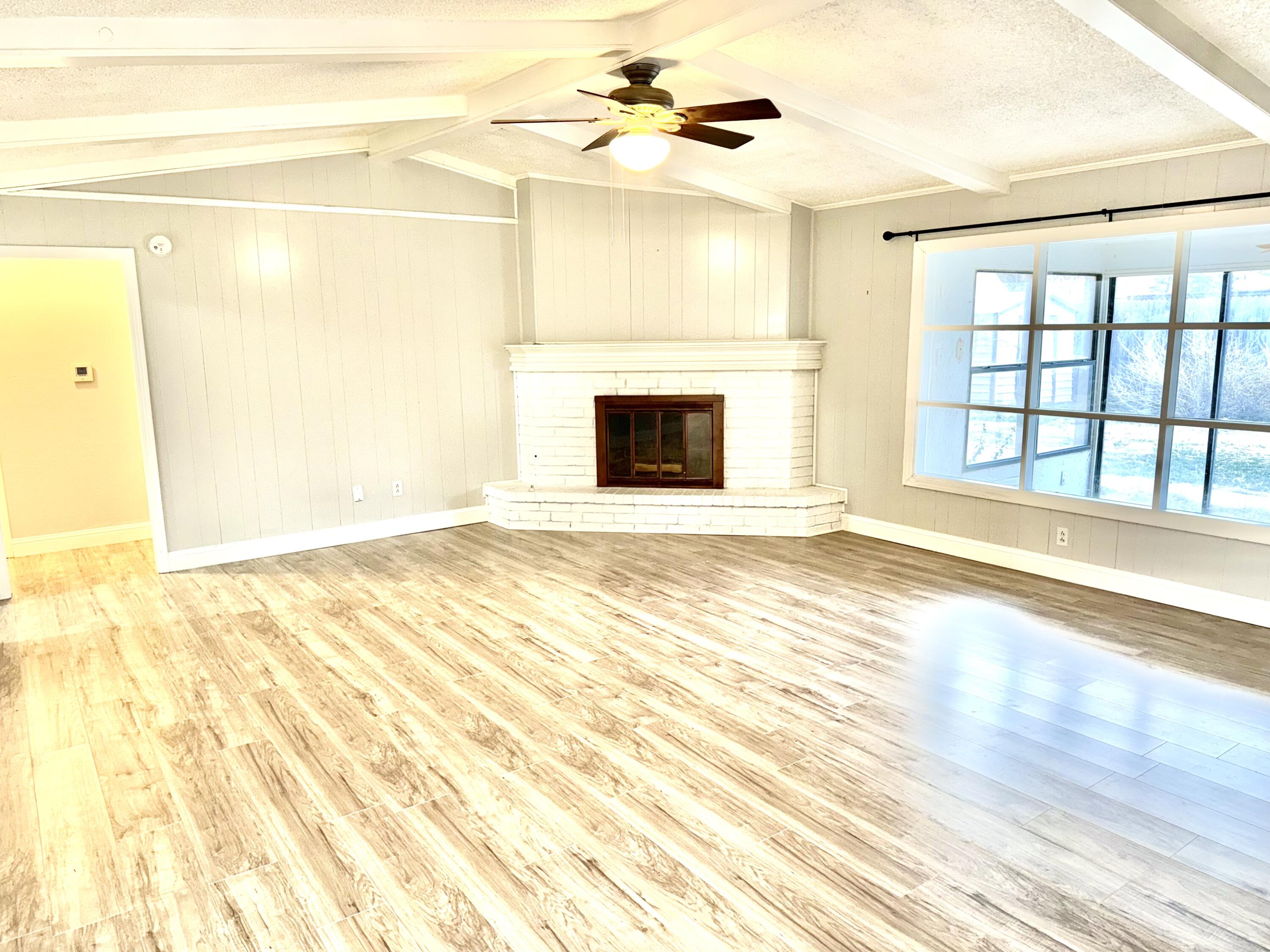 5415 73rd Street Lubbock, TX 79424 - Photo 4 of 13 a view of an empty room with a fireplace and a window