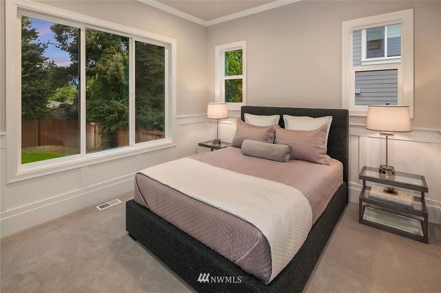 a spacious bedroom with a bed and a large window