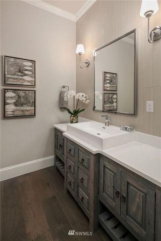 a bathroom with a double vanity sink and a mirror