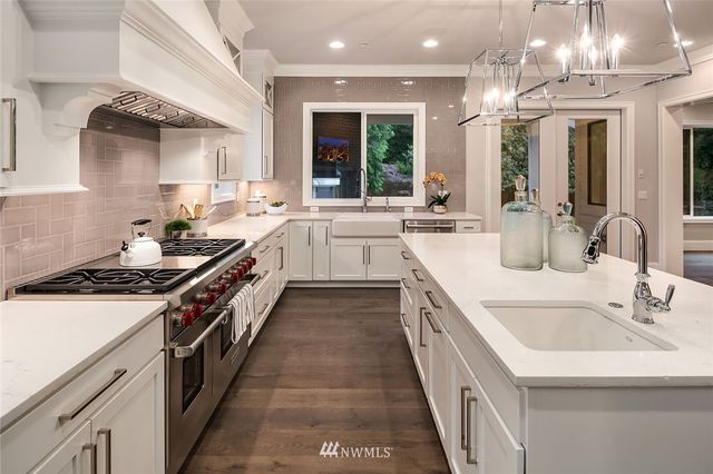 a kitchen with a sink stove and cabinets
