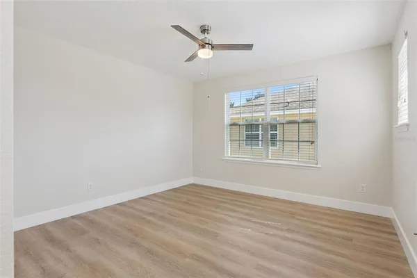 a view of a livingroom with a ceiling fan and wooden floor