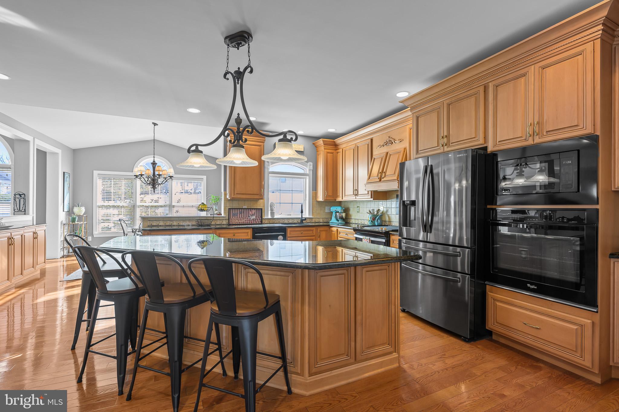 305 Williamson Way Downingtown, PA 19335 - Photo 6 of 60 a kitchen with stainless steel appliances a dining table chairs stove refrigerator and cabinets