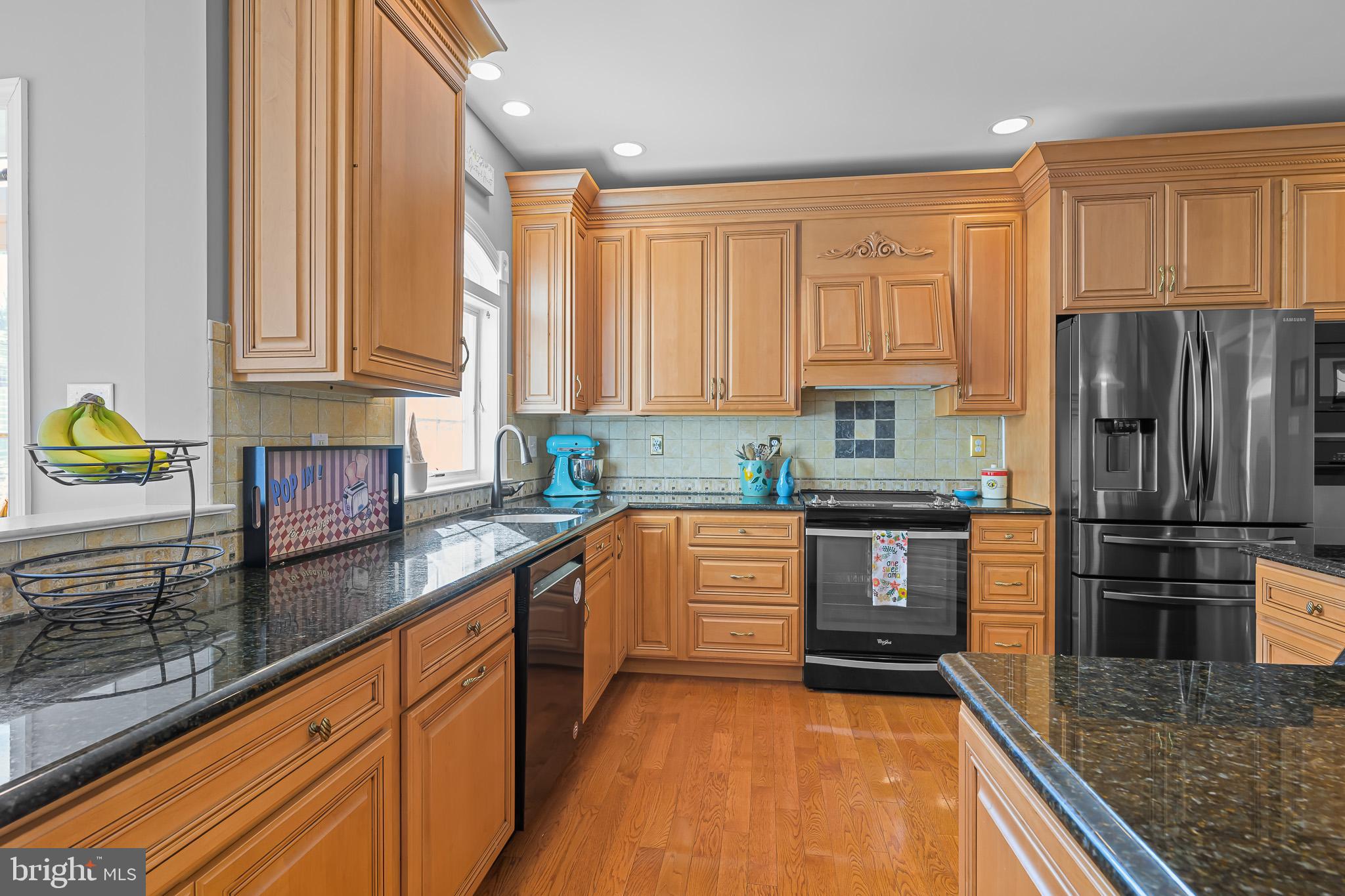 305 Williamson Way Downingtown, PA 19335 - Photo 7 of 60 a kitchen with stainless steel appliances granite countertop a refrigerator sink and cabinets