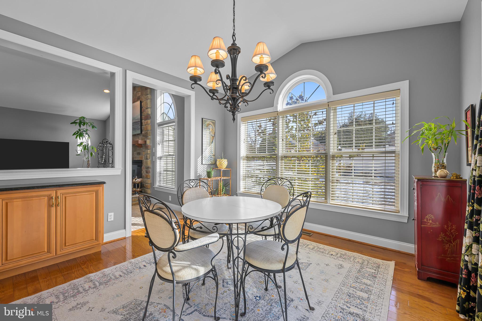 305 Williamson Way Downingtown, PA 19335 - Photo 10 of 60 a dining room with wooden floor a chandelier a wooden table and chairs