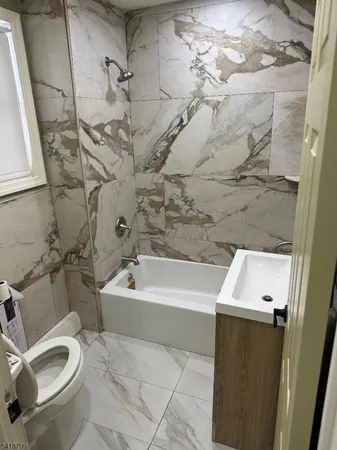 a bathroom with a sink a toilet and bathtub