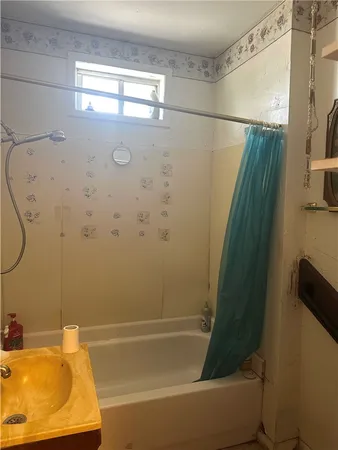 a bathroom with a shower and a tub