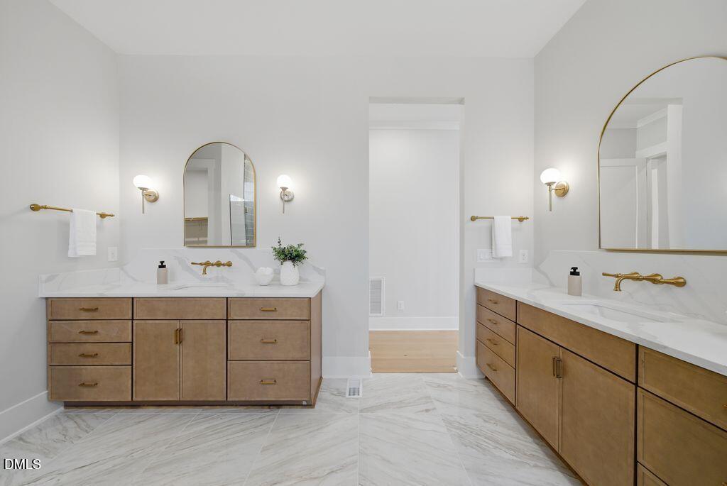1500 Shadowood Lane Raleigh, NC 27612 - Photo 11 of 39 a spacious bathroom with double sink and a mirror
