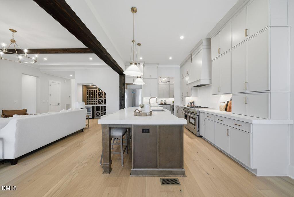 1500 Shadowood Lane Raleigh, NC 27612 - Photo 13 of 39 a kitchen with counter top space sink and center island