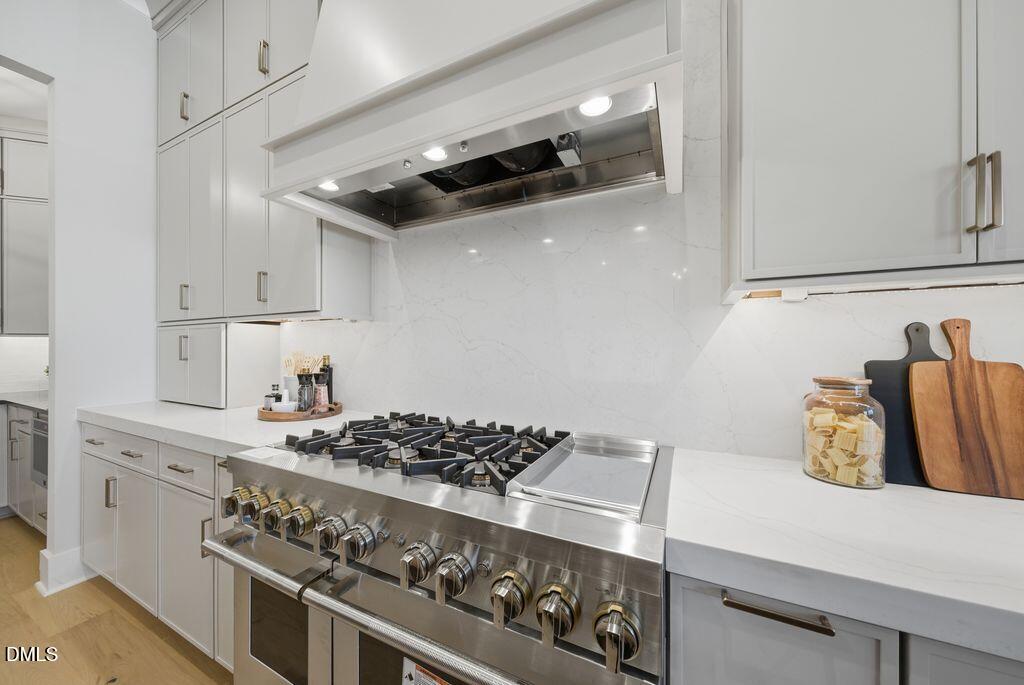 1500 Shadowood Lane Raleigh, NC 27612 - Photo 14 of 39 a kitchen with stainless steel appliances granite countertop a stove and a refrigerator