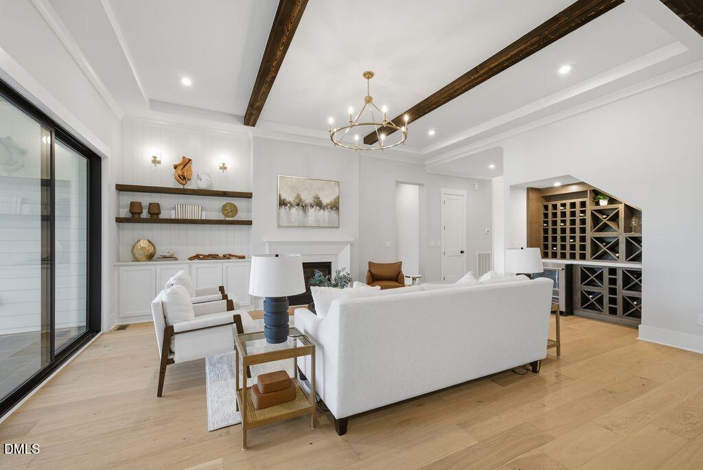 1500 Shadowood Lane Raleigh, NC 27612 - Photo 23 of 39 a living room with furniture a fireplace and a large window