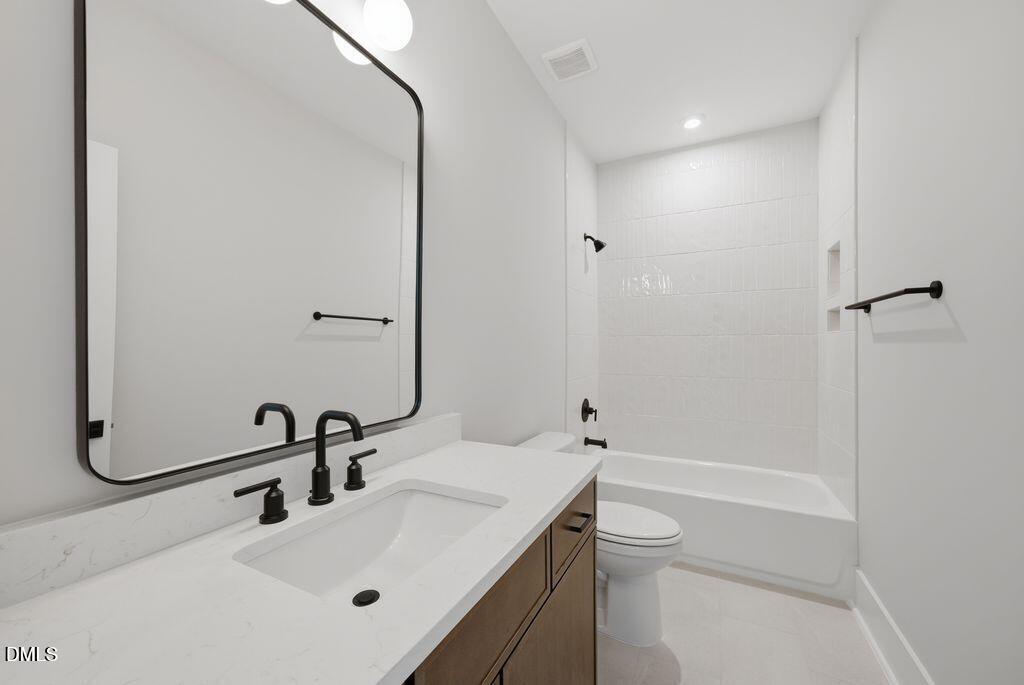 1500 Shadowood Lane Raleigh, NC 27612 - Photo 31 of 39 a bathroom with a sink a toilet and shower