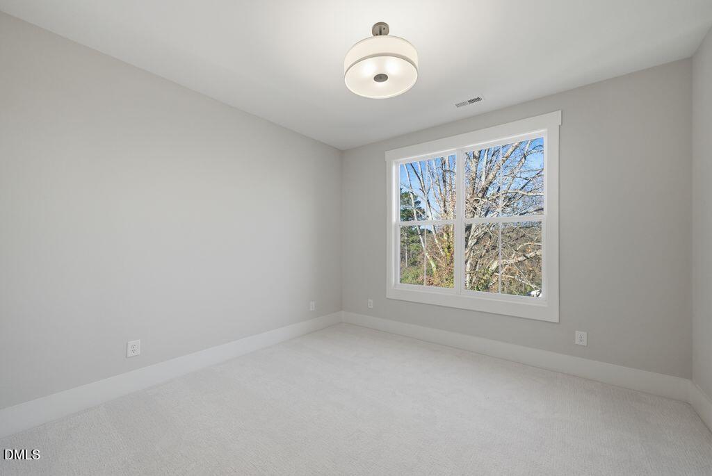 1500 Shadowood Lane Raleigh, NC 27612 - Photo 32 of 39 an empty room with a window