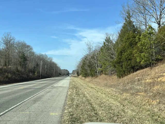 a view of a road with a wrought fence