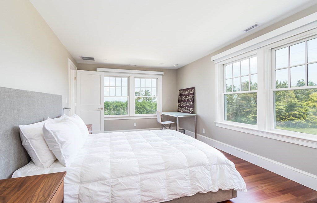 35 Sunset Point Road Falmouth, MA 02556 - Photo 23 of 27 a large bed sitting in a bedroom next to a window