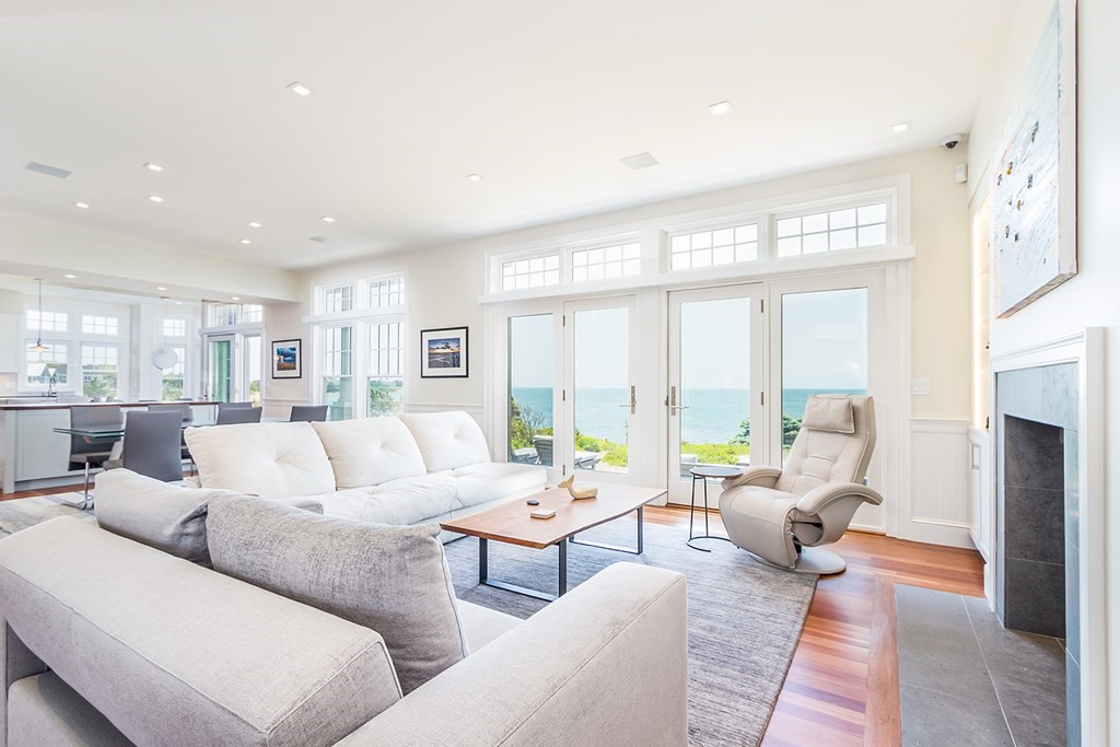 35 Sunset Point Road Falmouth, MA 02556 - Photo 4 of 27 a living room with furniture large windows and a fireplace