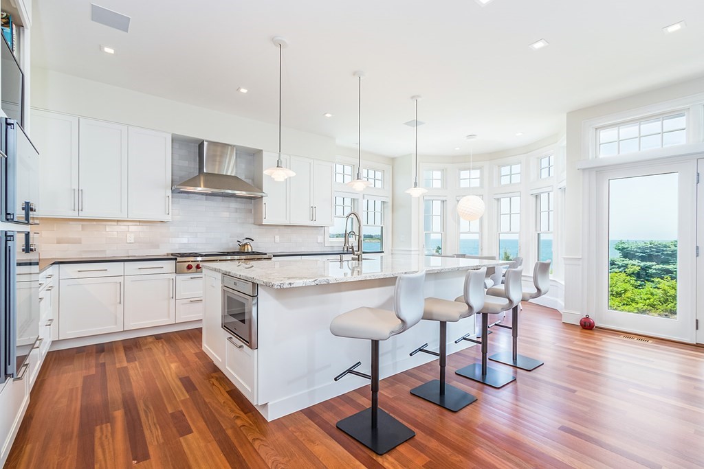 35 Sunset Point Road Falmouth, MA 02556 - Photo 8 of 27 a kitchen with stainless steel appliances granite countertop wooden floor window and white cabinets