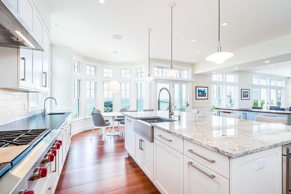 35 Sunset Point Road Falmouth, MA 02556 - Photo 9 of 27 a large kitchen with kitchen island a stove a sink a center island and windows