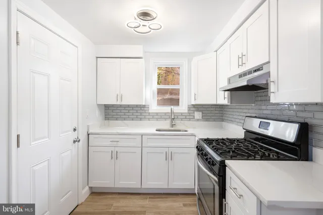 a kitchen with cabinets appliances and a window