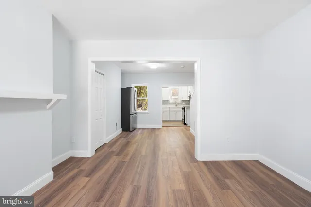 a view of a room with wooden floor and a bathroom